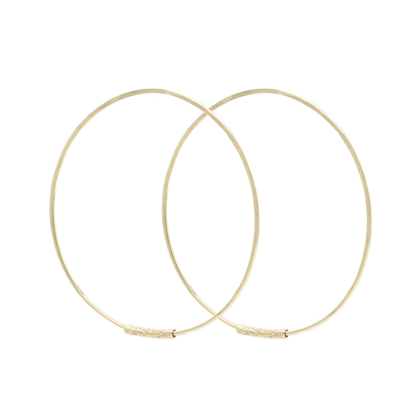 Medium sized Featherweight Hoops in solid 14k gold by Erin Cuff Jewelry.